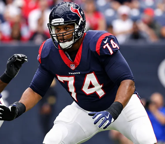 Chris Clark playing football in a Houston Texans navy number 74 uniform